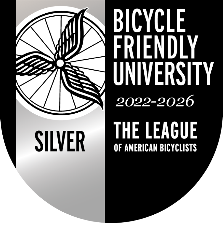 Black and silver logo with a bike wheel that says "Bicycle Friendly University 2022-2026, Silver"