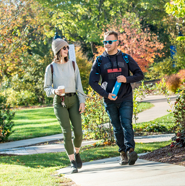 Students walking during a sunny fall day at Champlain College in Burlington, Vermont