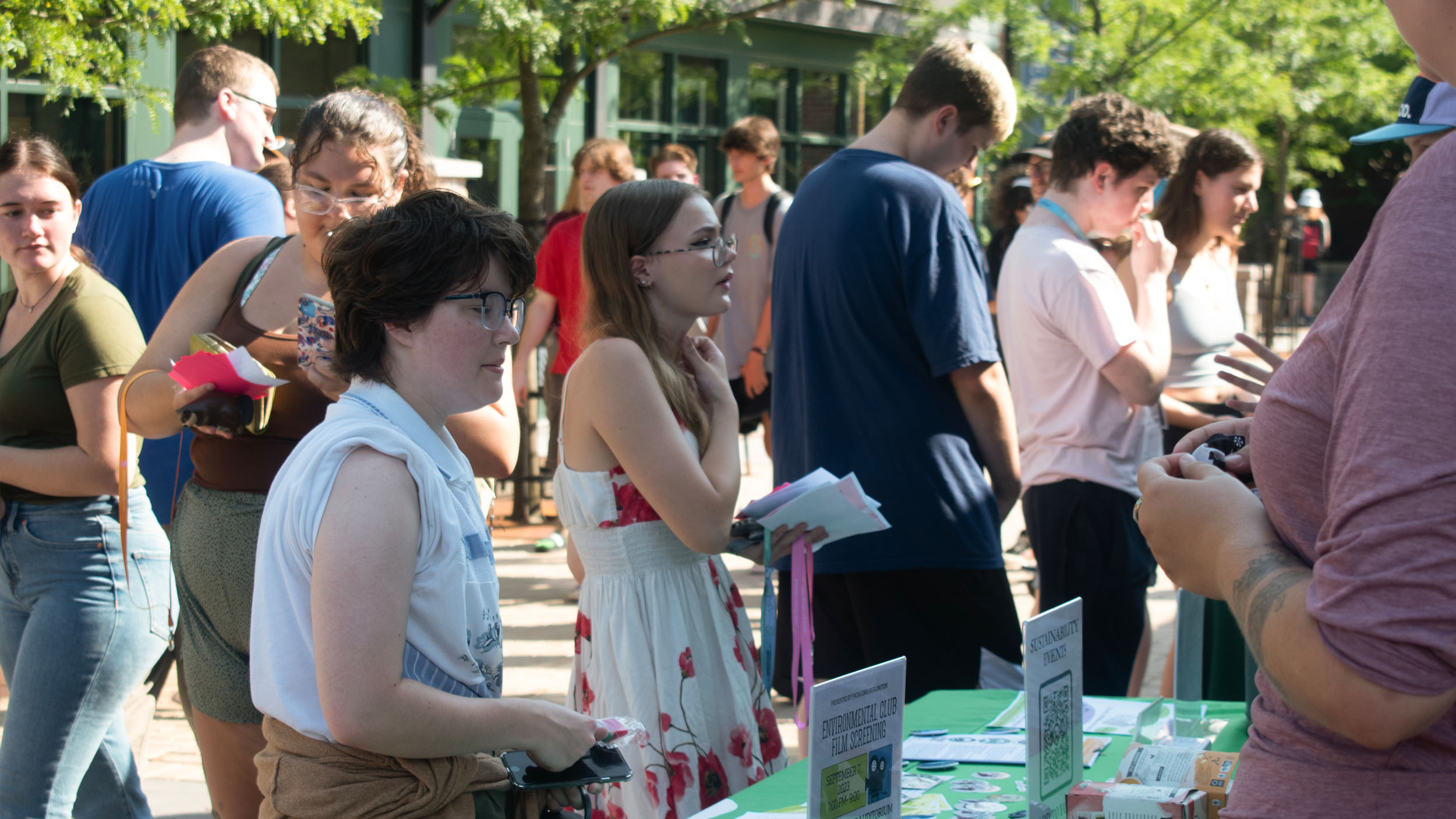 Students talking with club heads at the 2024 club and activity fair outside