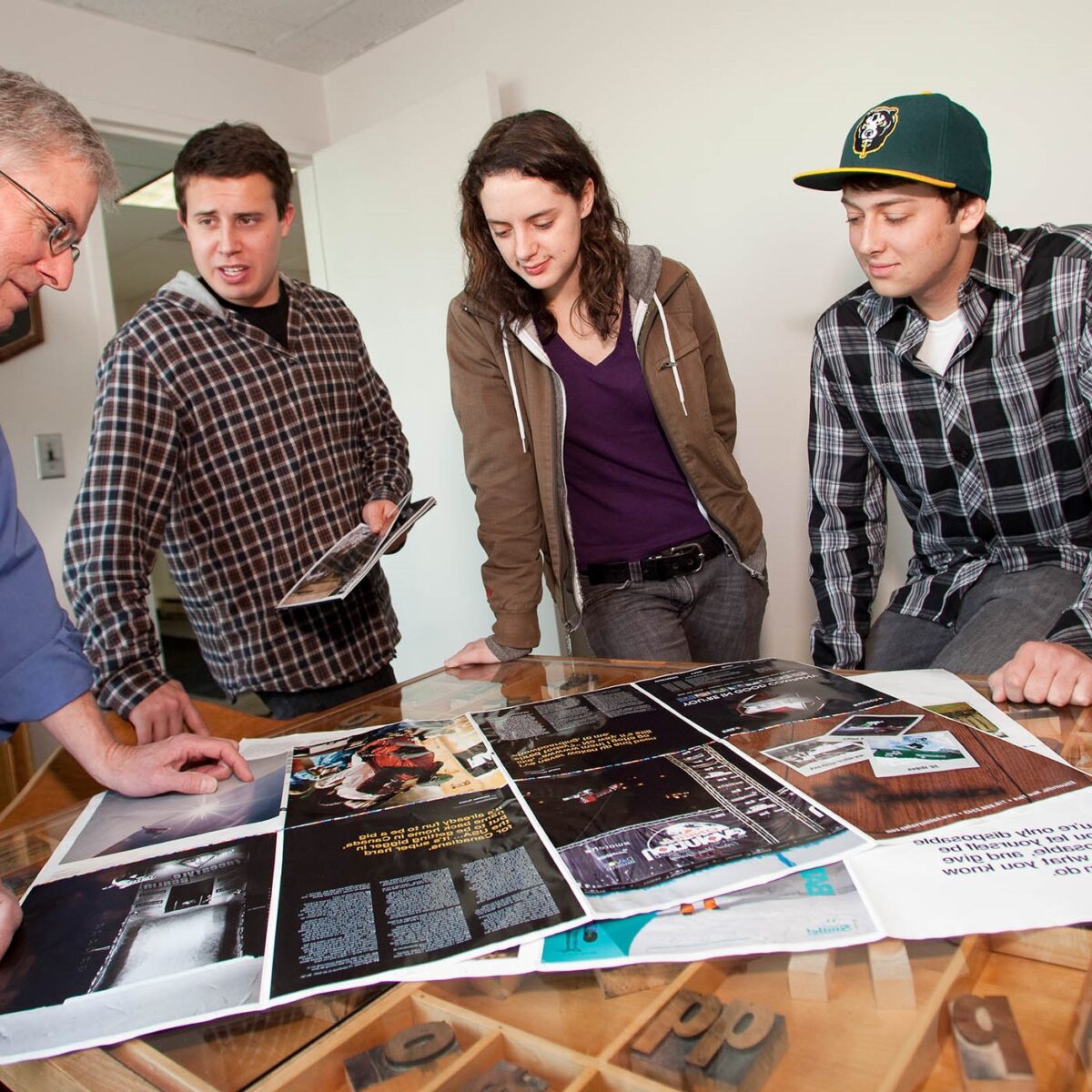 CCM Students Reviewing printer proof at Queen City Printers with Alan Schillhammer