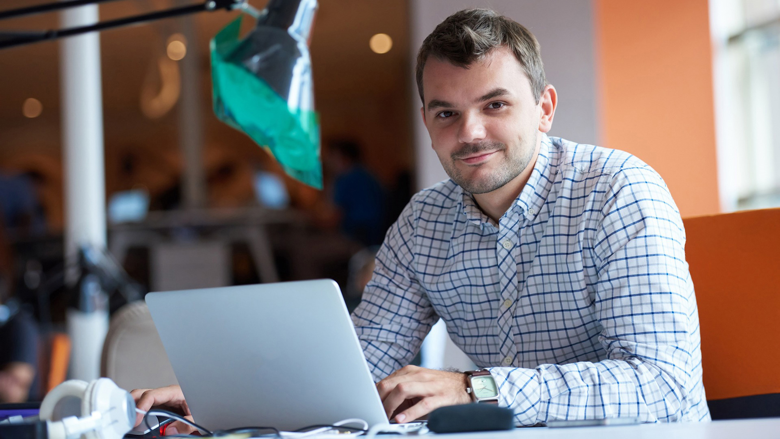 a student at a laptop looks at the camera