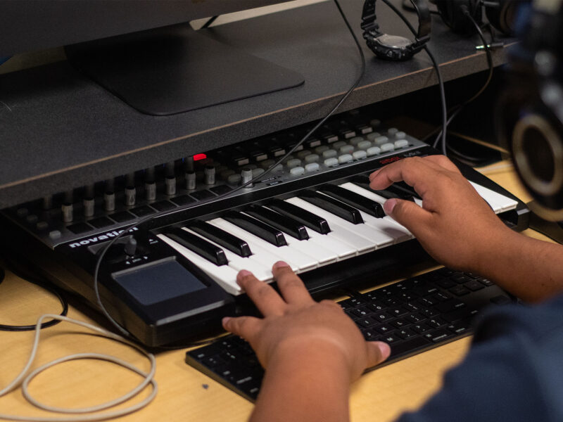 student recording audio from a musical keyboard