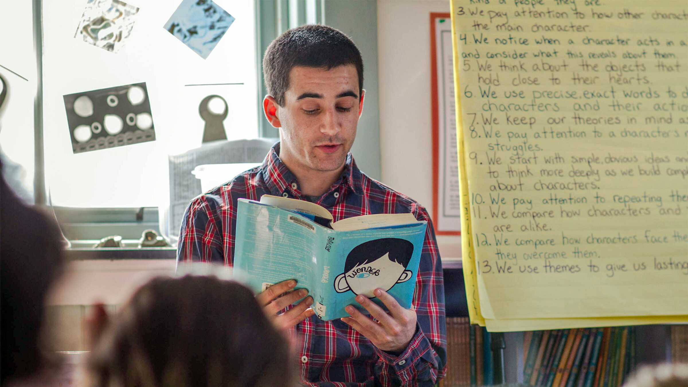 student teacher reads to children in a classroom