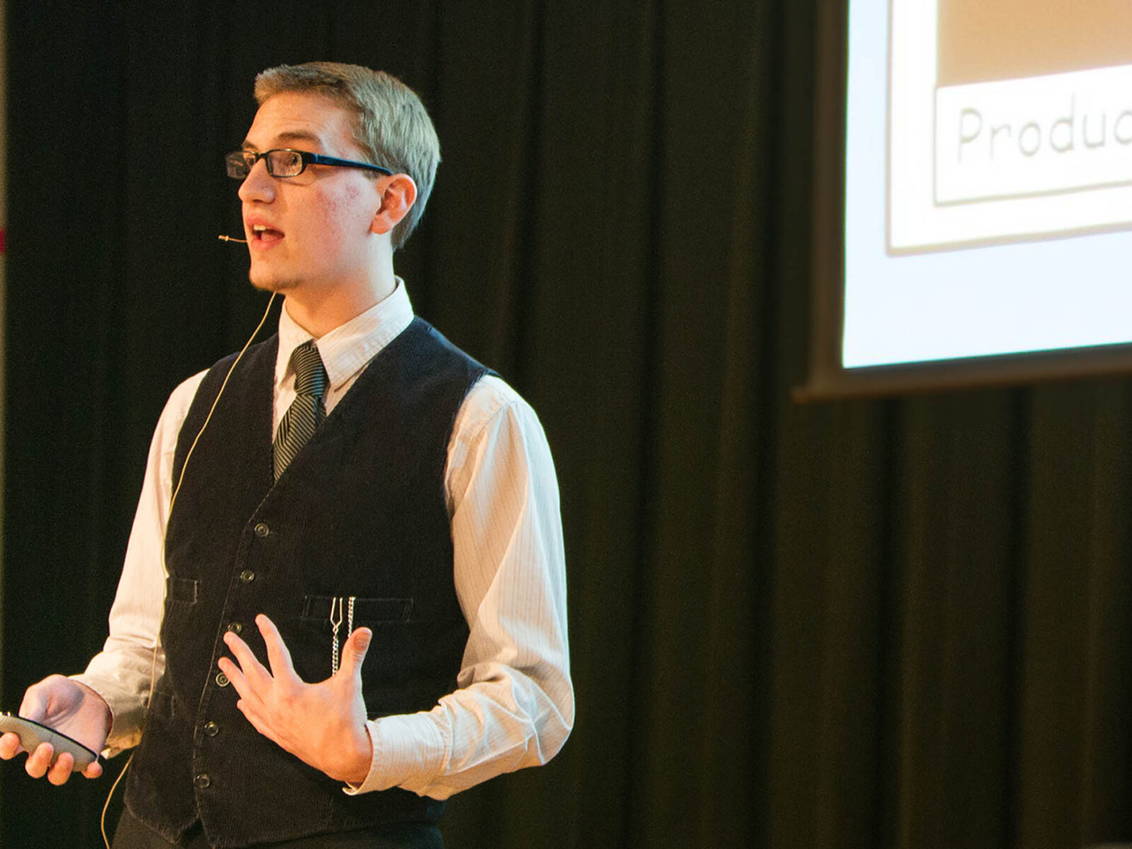 a game business student delivering a game presentation at a large event