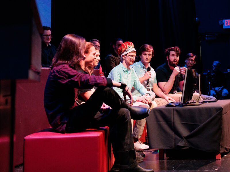 a group of game studio students unveiling their new game at the senior game show
