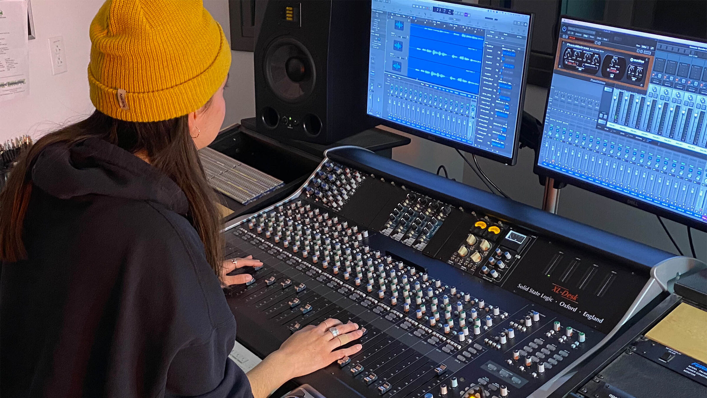 Student mixing audio using professional equipment