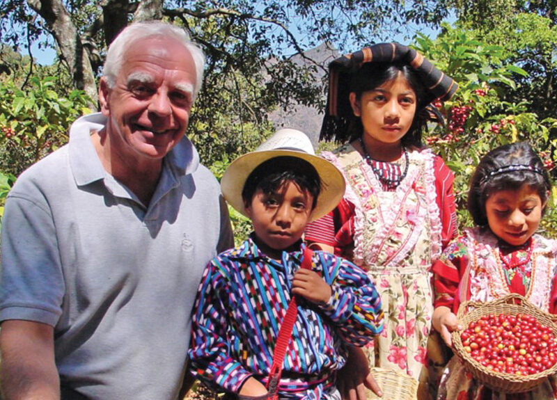 bob stiller poses with 3 children on a coffee farm