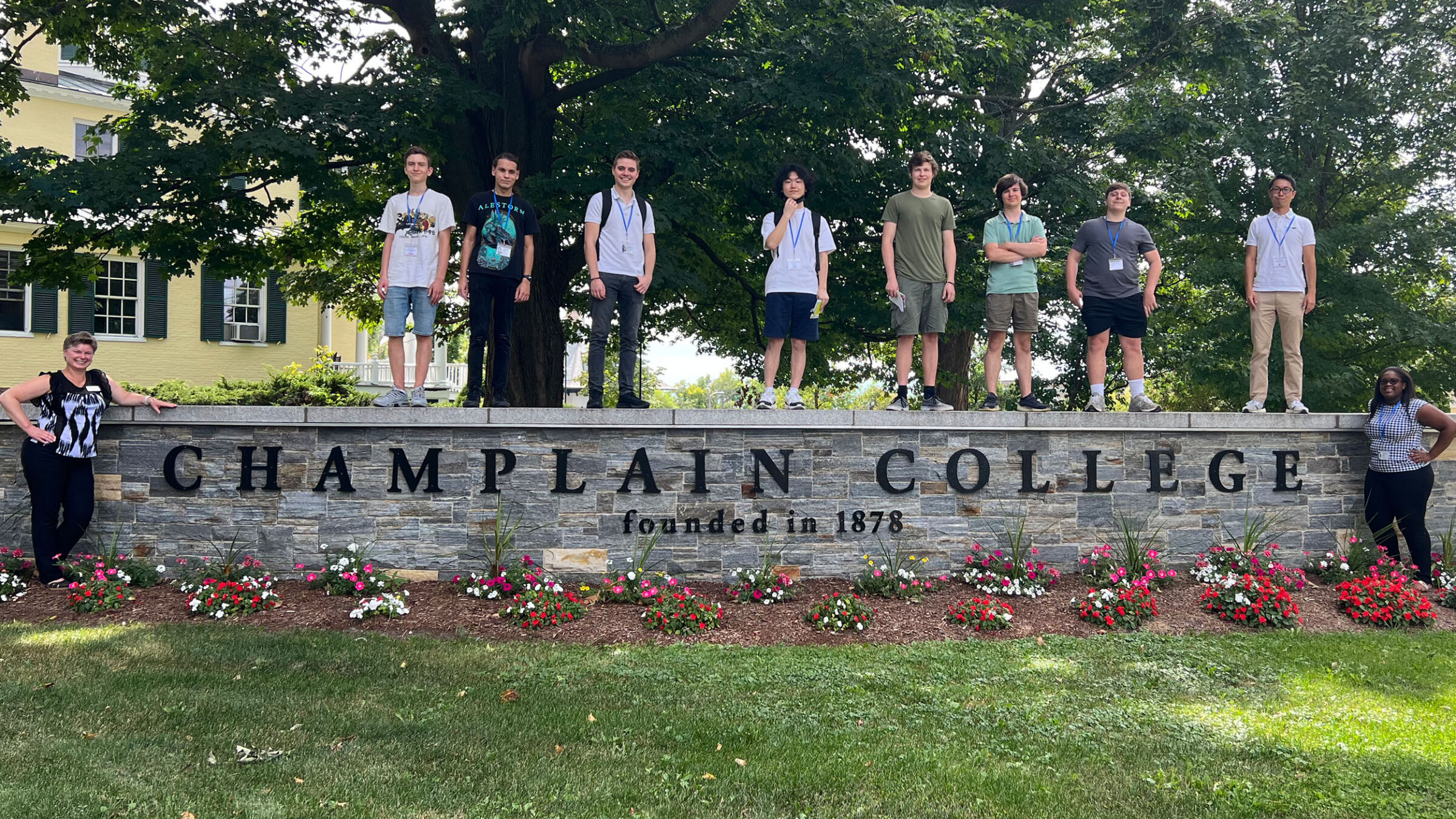 international students posing over the champlain college sign for international orientation