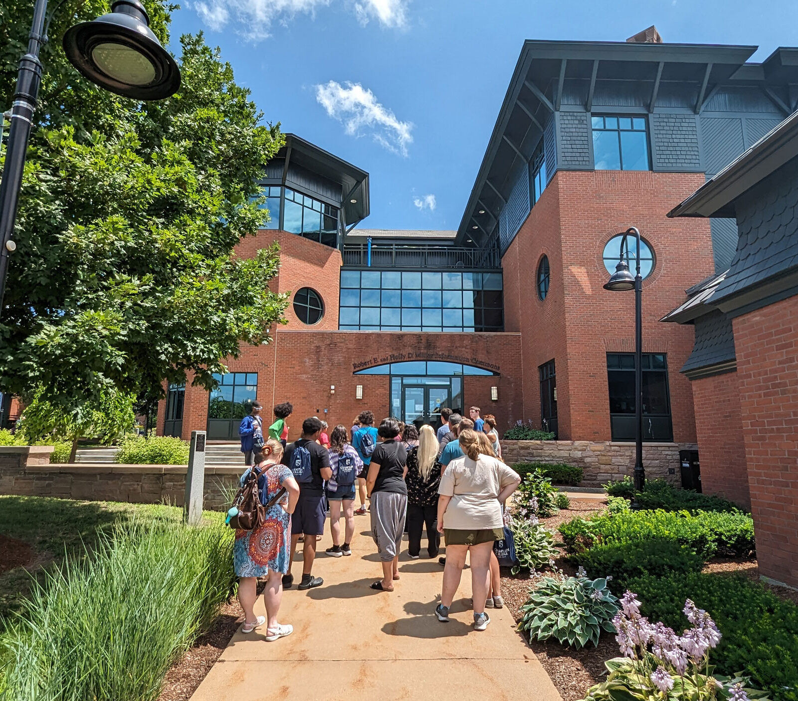 A tour group at Champlain College walks toward the library