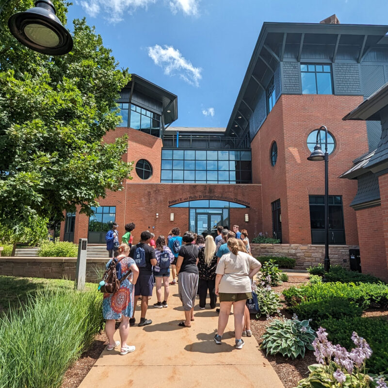 A tour group at Champlain College walks toward the library