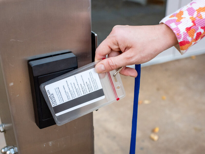 close up of hand swiping a key card to enter a building