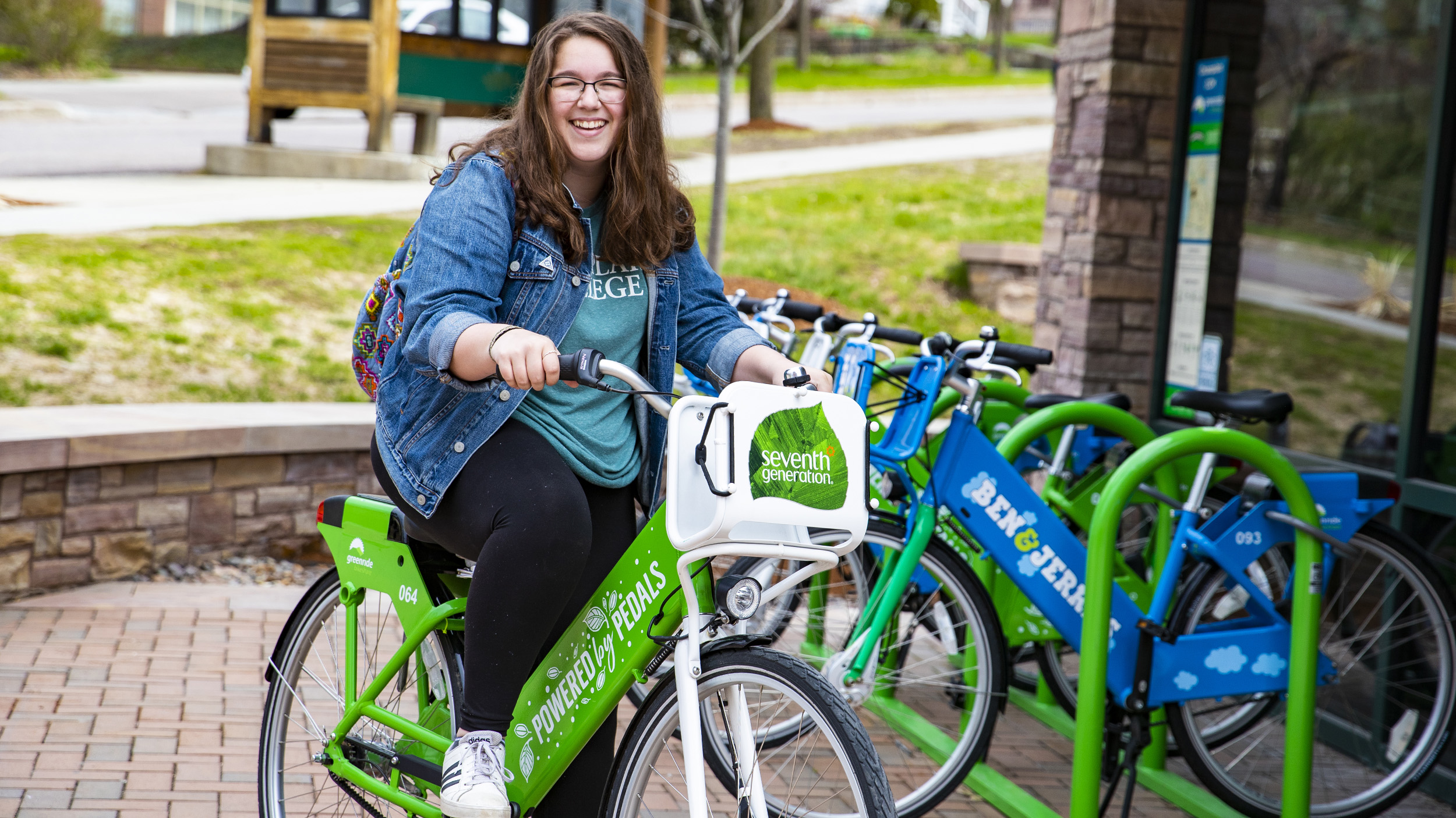 a student uses a green bicycle