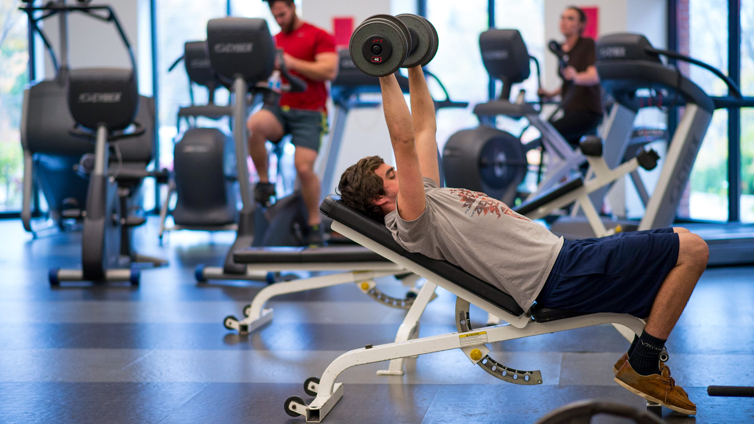 student weight trains in the fitness center