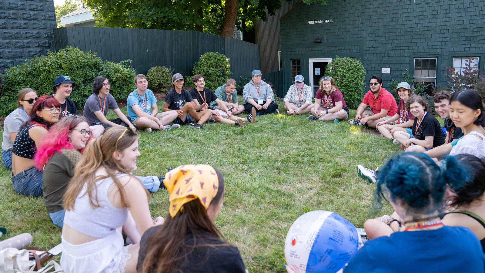 new students gather in a circle outside for orientation and games