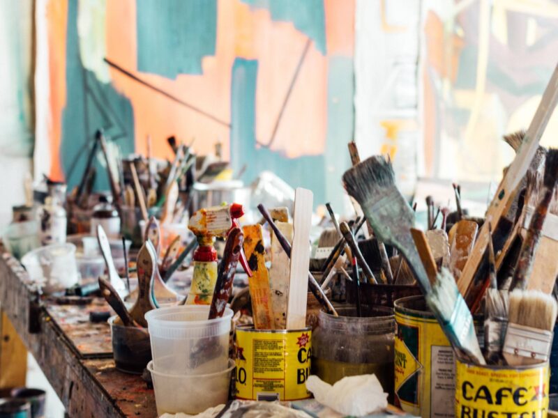 painting supplies on an art desk in a studio