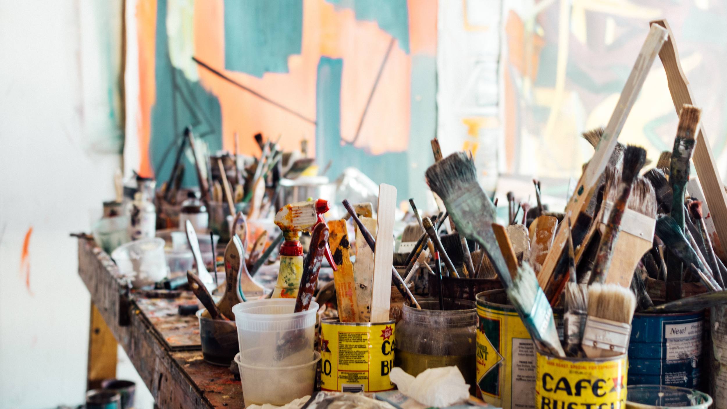 painting supplies on an art desk in a studio