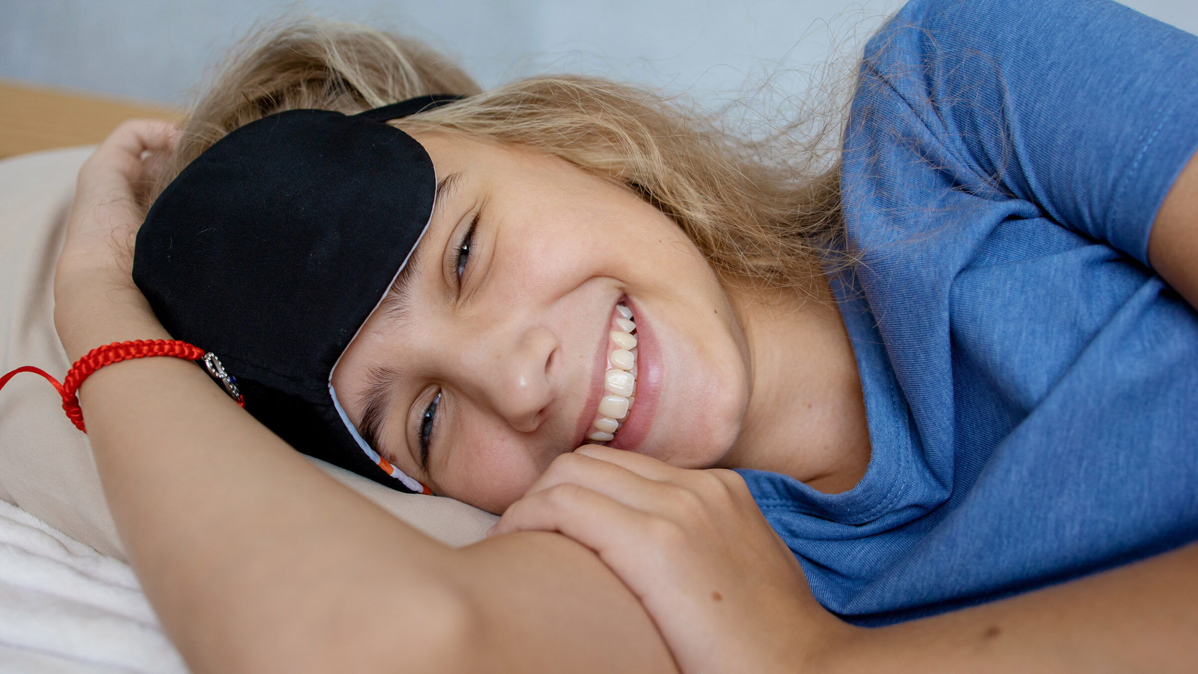 portrait of a teenage girl in a sleep mask. Happy smile and good mood