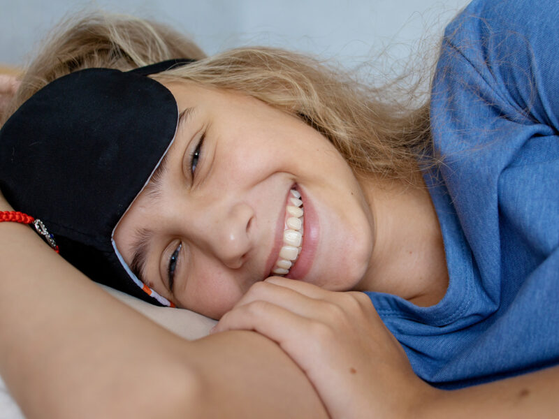 portrait of a teenage girl in a sleep mask. Happy smile and good mood