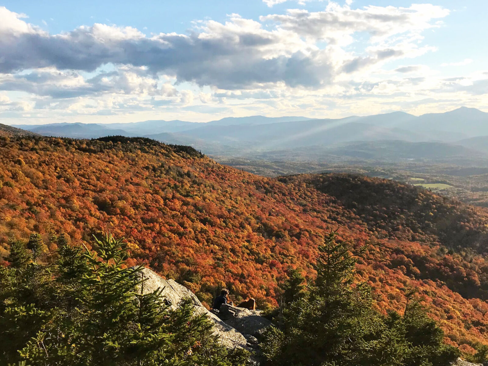 View of fall foliage from the top of a mountain in Vermont.