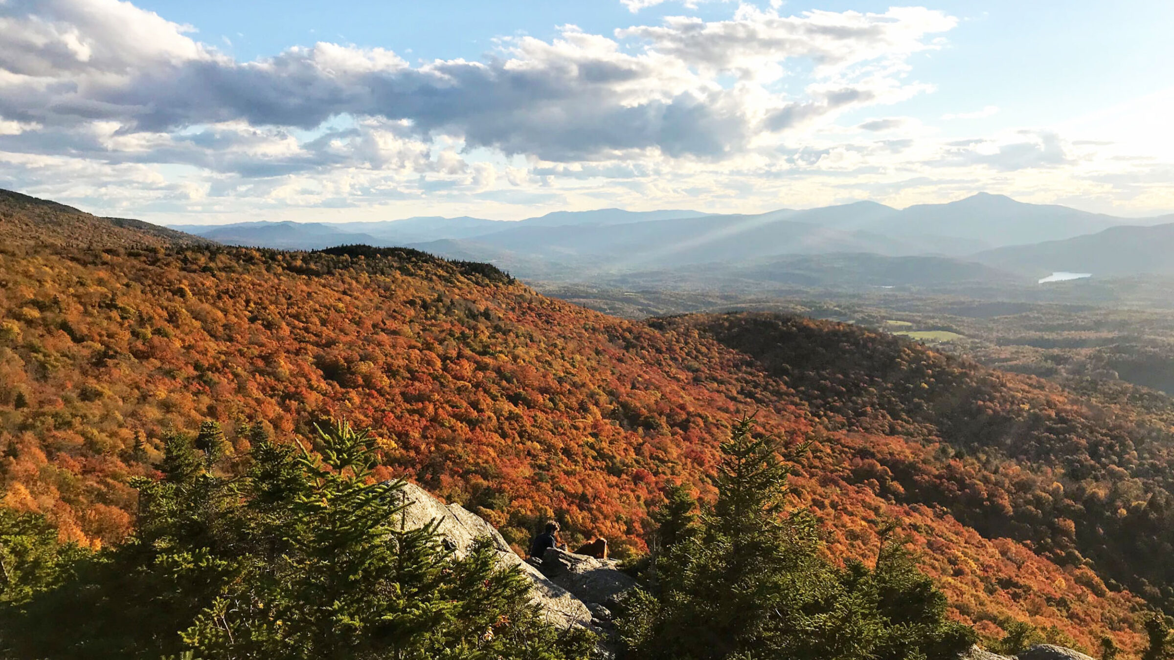 View of fall foliage from the top of a mountain in Vermont.