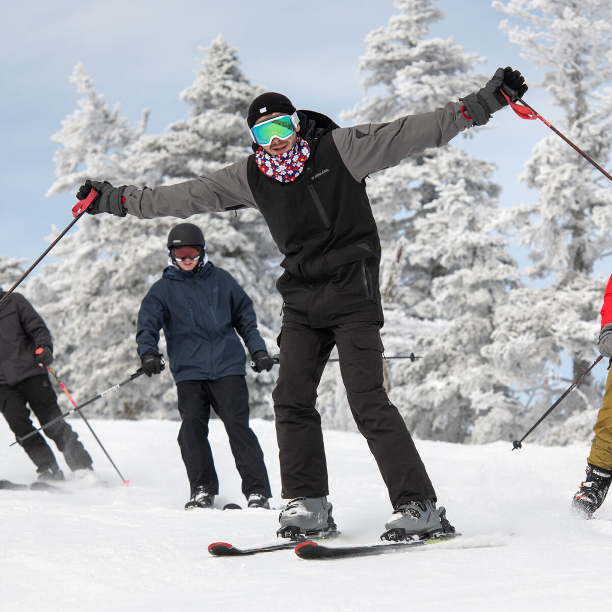 skier with arms outstretched on a ski slope