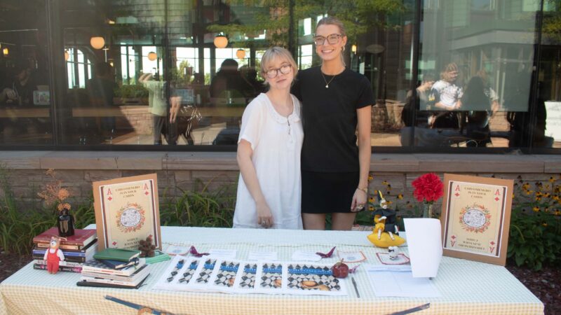 Student standing behind Chivomengro club table outside