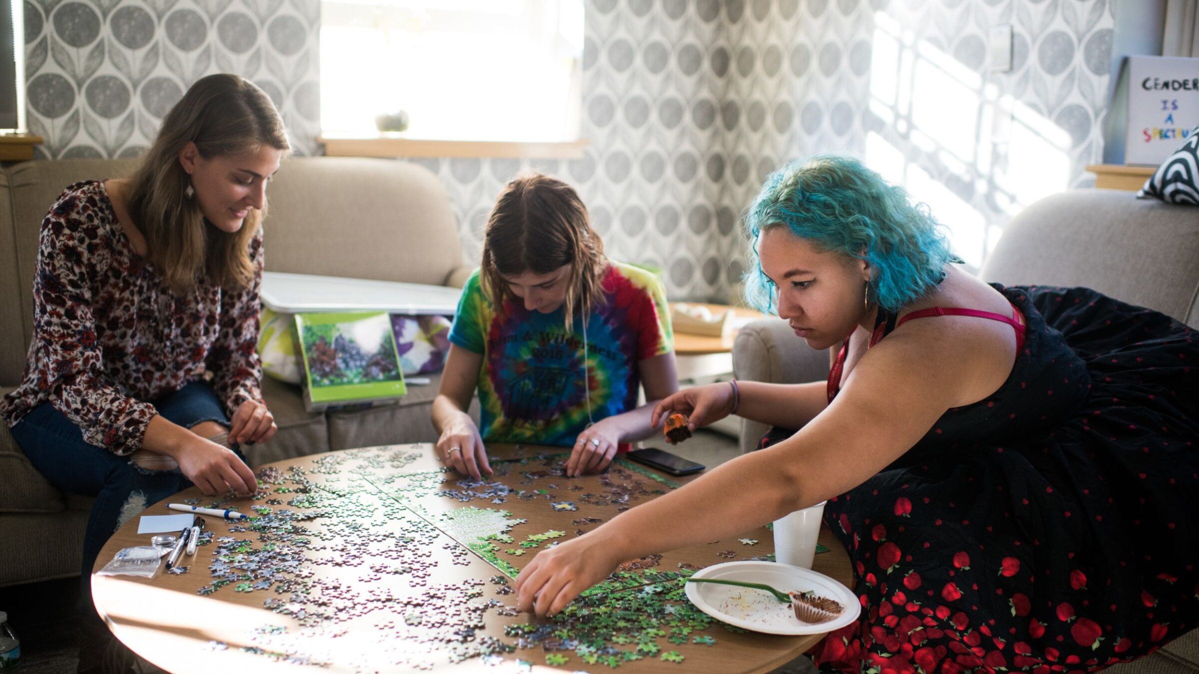 Students in the WGC completing a puzzle with sunlight shining through the window