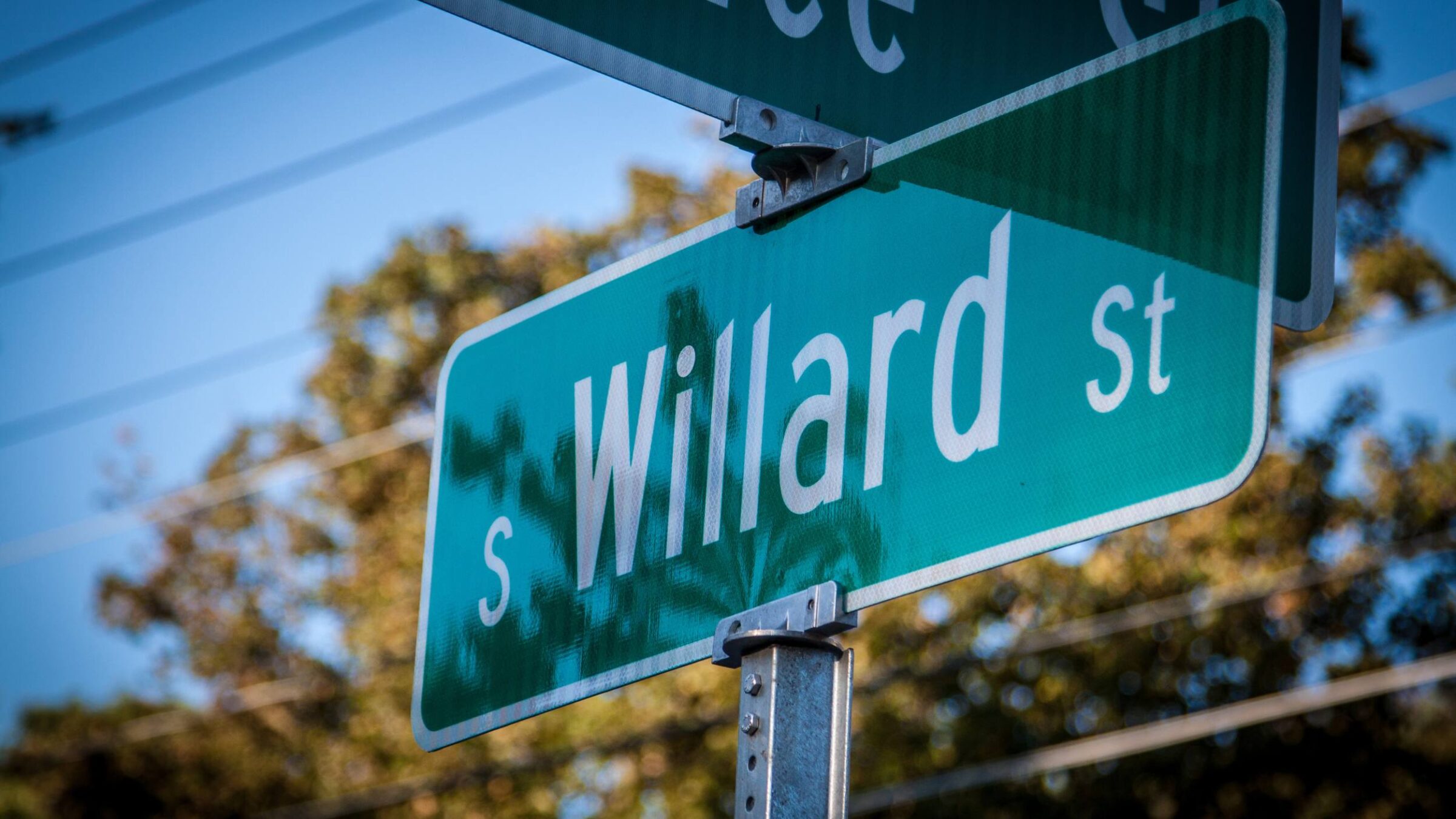 A sunny photo of the south willard street sign in Burlington