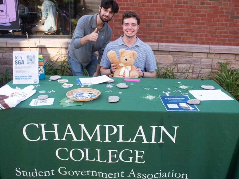 Student Government Associations activity fair table with two students smiling for the photo