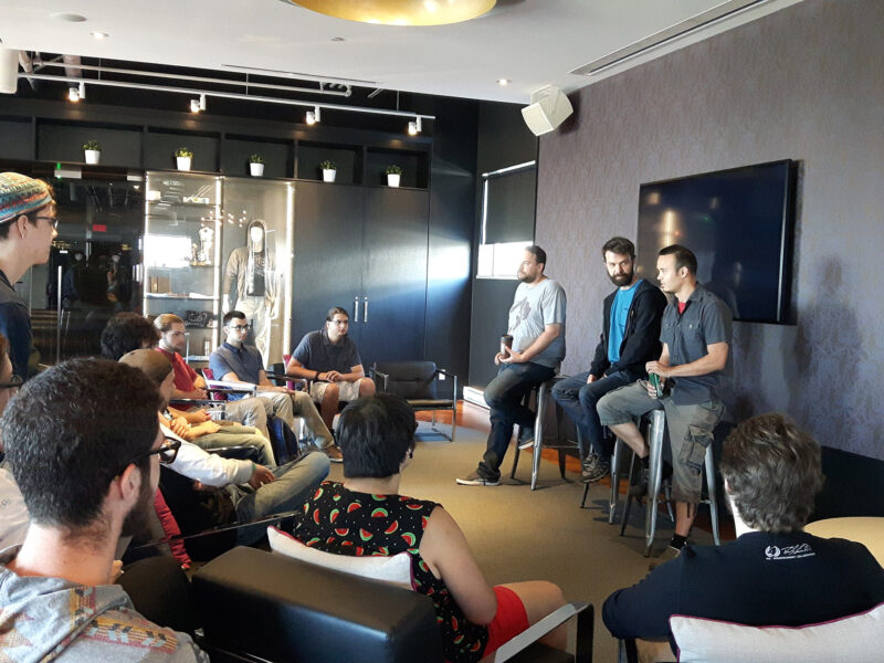 group of student listen to professionals at a company visit