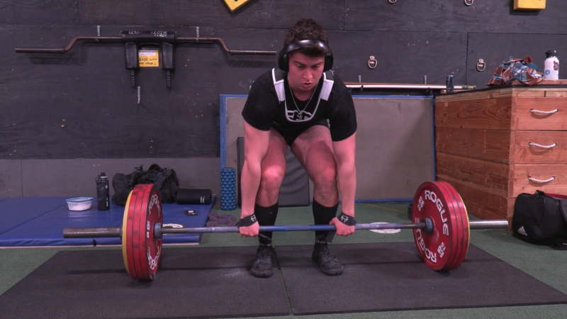 student Jordan Bourdeau about to perform a dead-lift in the gym