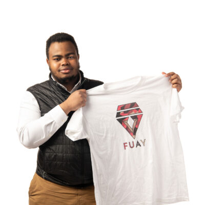 Ahmed Adan holds one of his t-shirt designs.