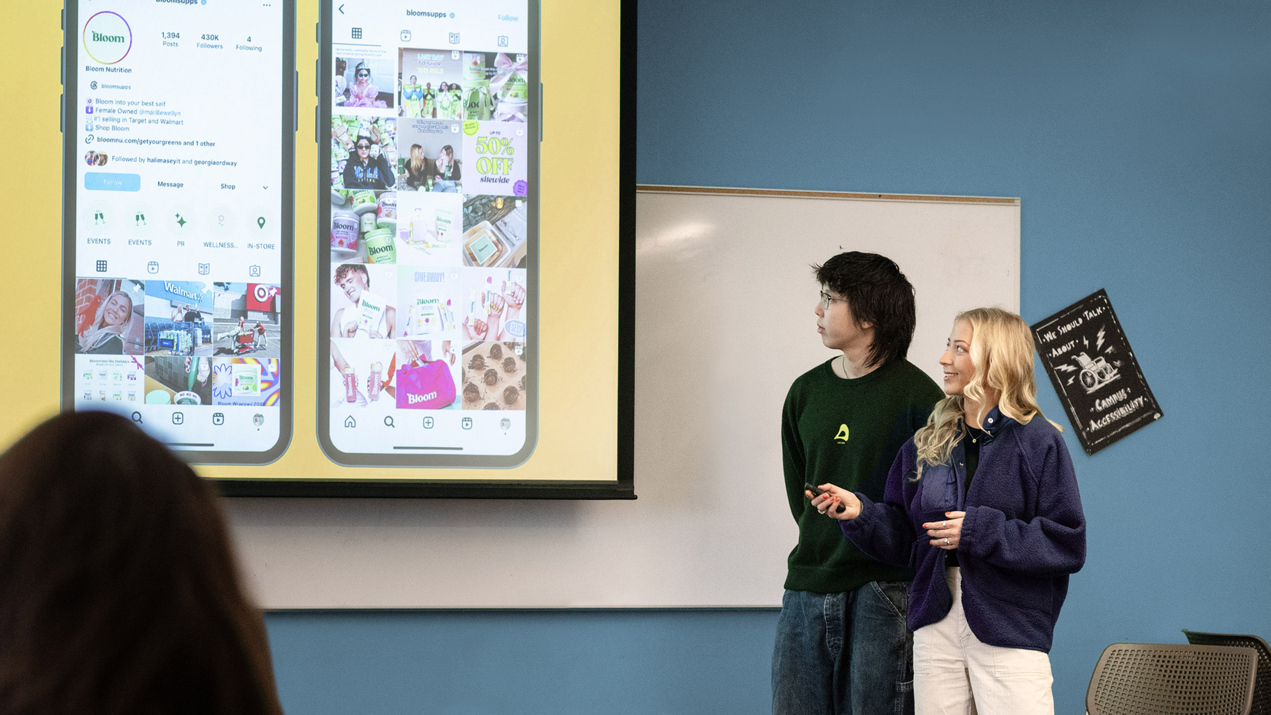 two students present at the front of the class