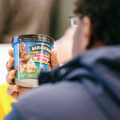 person looks closely at a Ben & jerry's ice-cream container