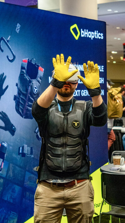person using a vr headset and gloves at a gaming conference