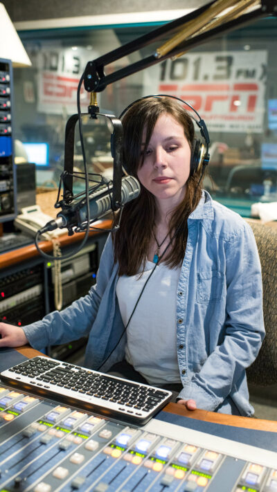 a student intern in a radio booth
