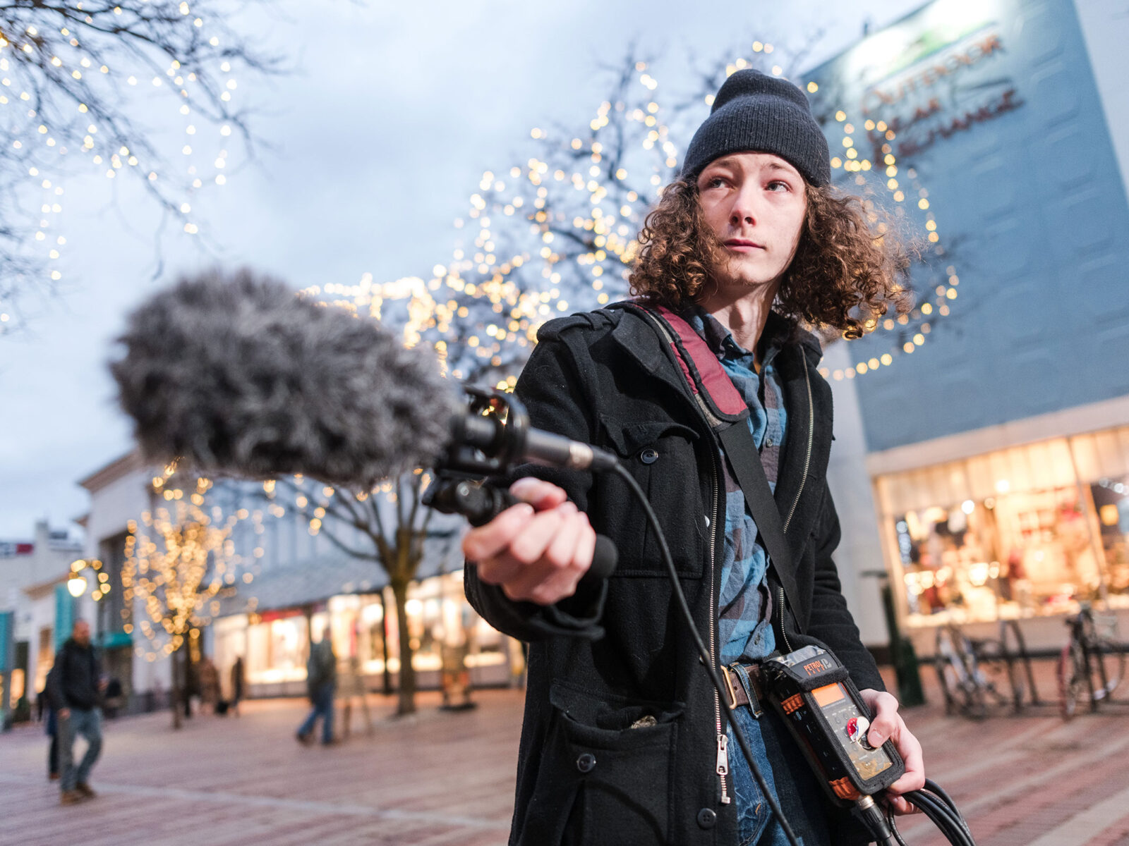 Champlain student records sound on Church Street with a boom mic