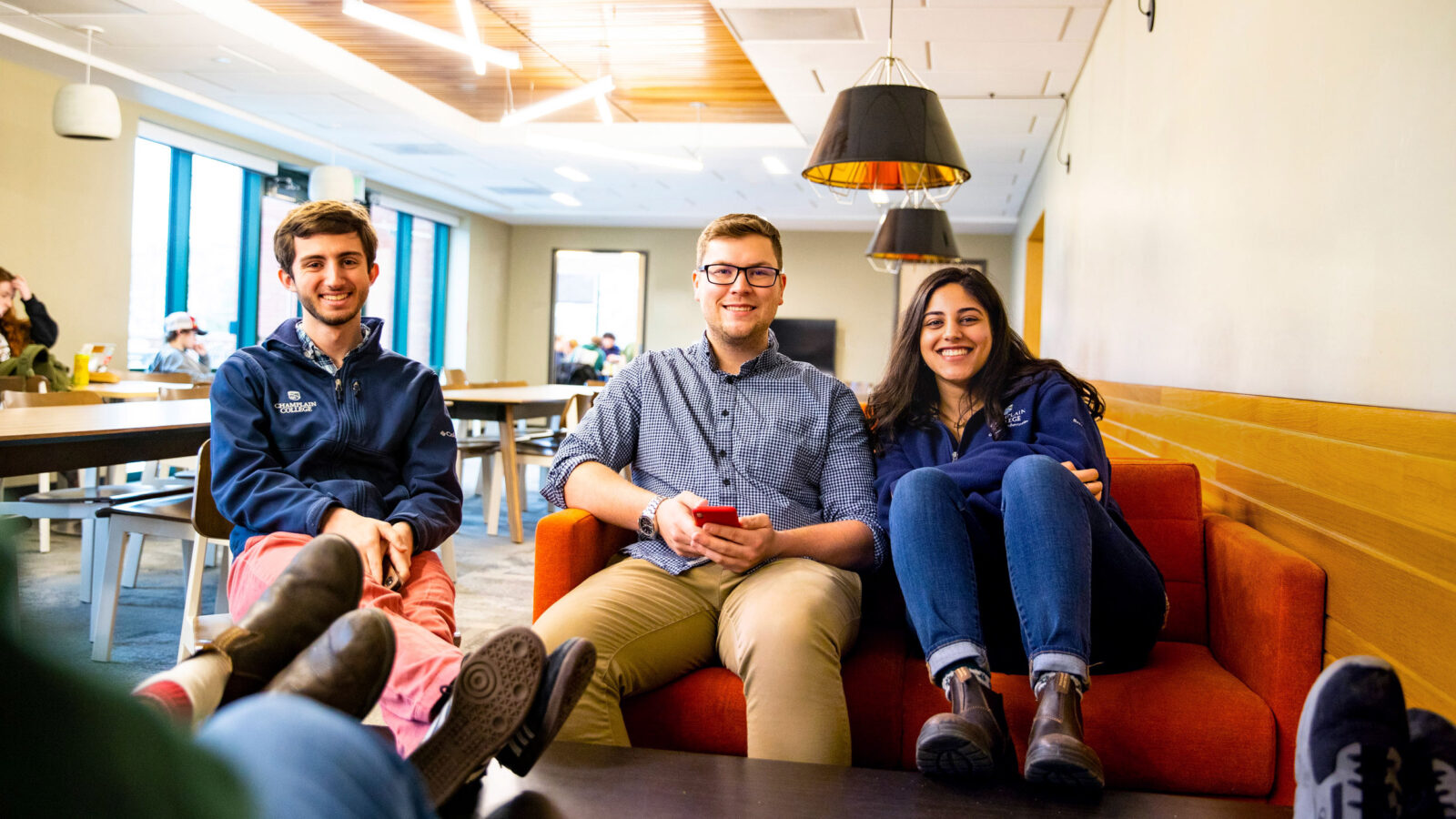 Three students hang out in the EATS Lounge at Champlain College