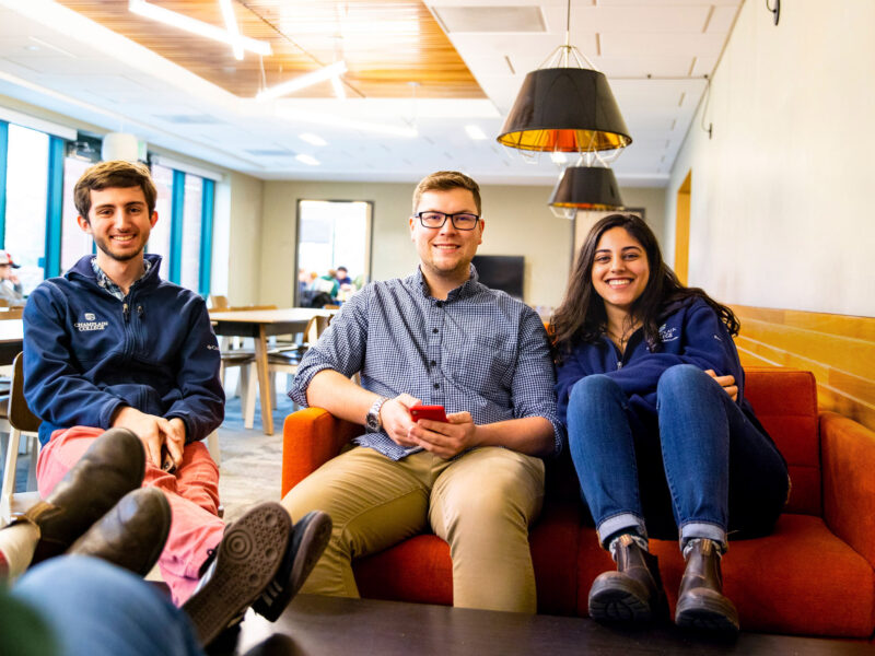 Three students hang out in the EATS Lounge at Champlain College