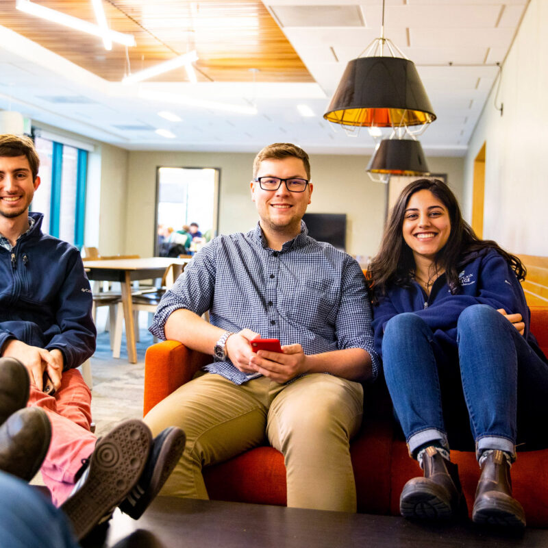 Three students hang out in the EATS Lounge at Champlain College