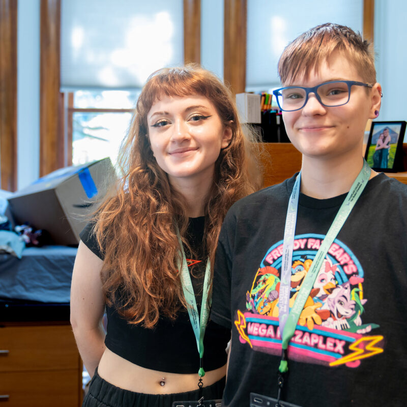 roommates stand side by side in new res hall room