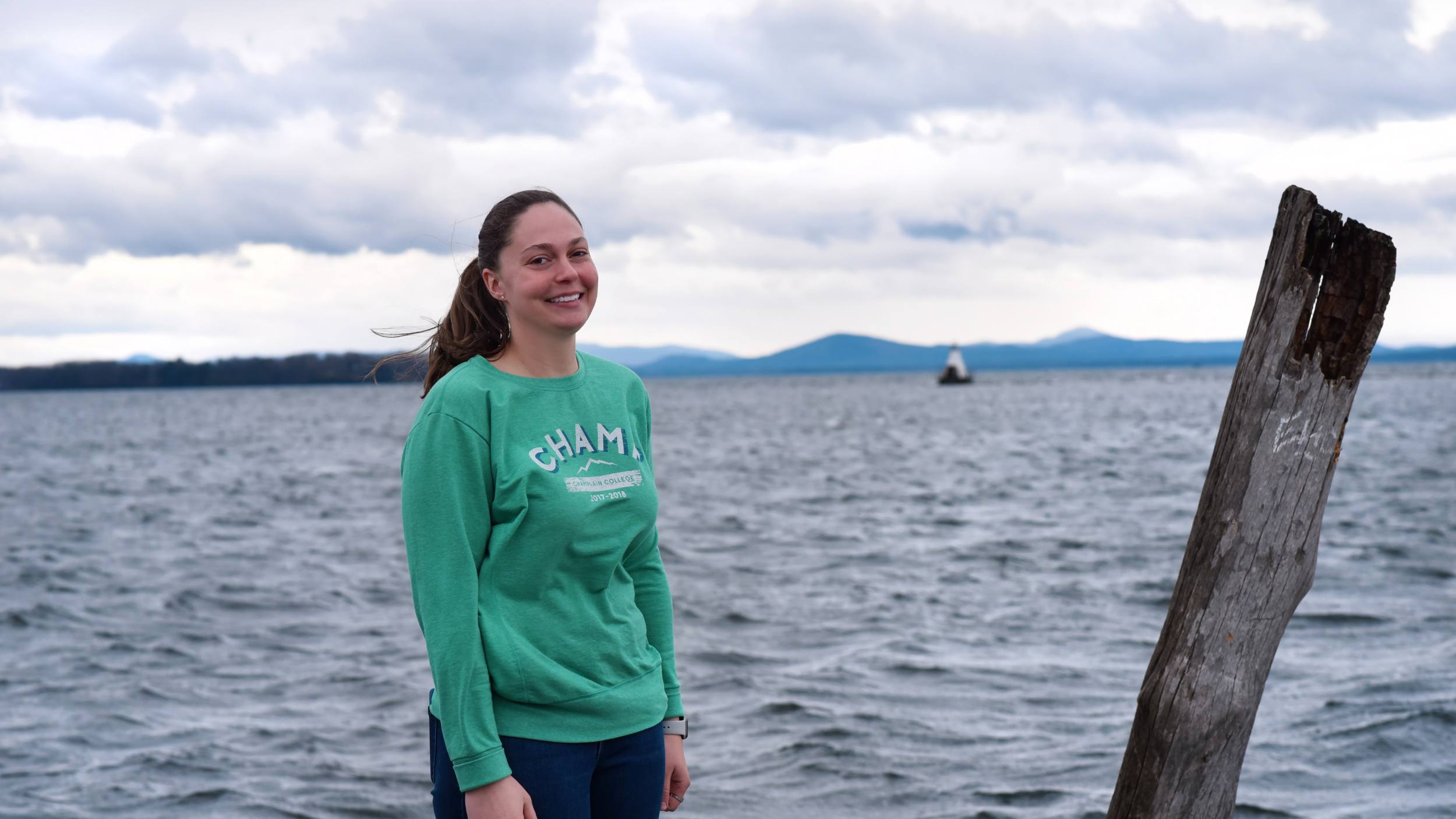 Liza Ryan standing in front of Lake Champlain smiling