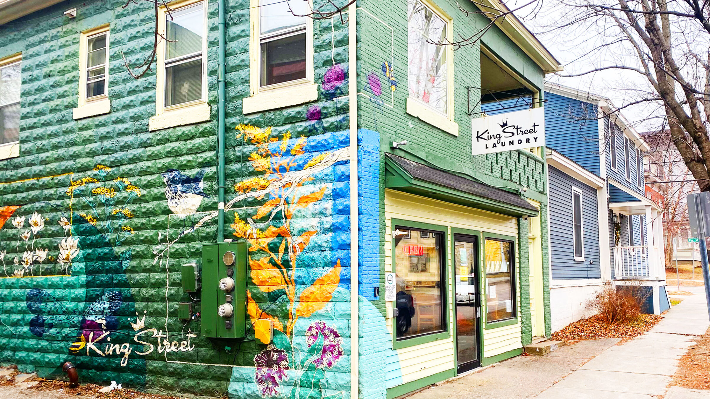 The exterior of King Street Laundry painted green and blue