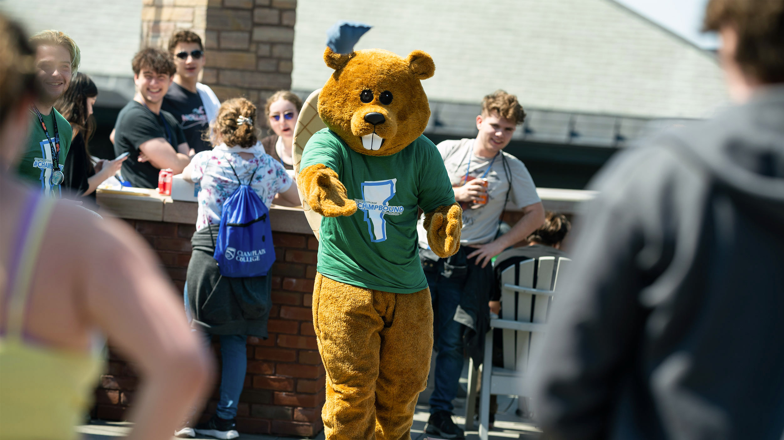 chauncey plays cornhole with admitted students outside on the terrace