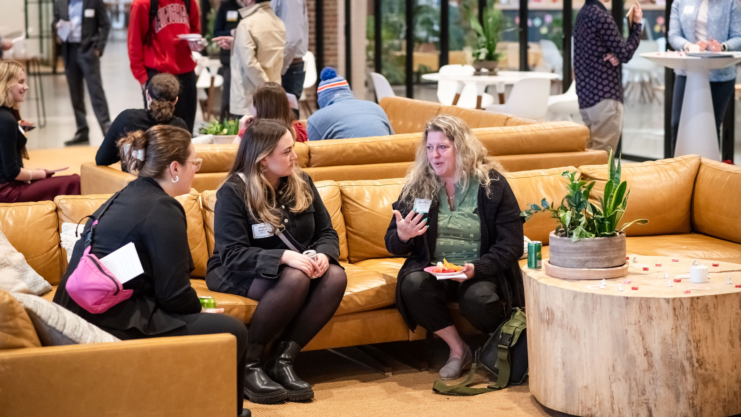 Two students network with a professional at an event at the Hula co-working campus.