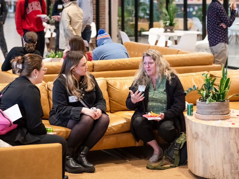 Two students network with a professional at an event at the Hula co-working campus.