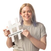 Tori Long holds a hashtag cut out that says "#WomenInBusiness"