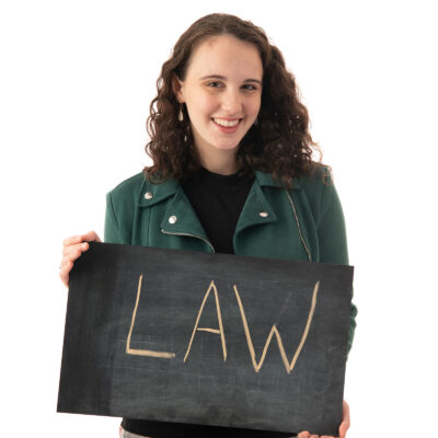 Maggie Hufnagel holds a "Law' sign
