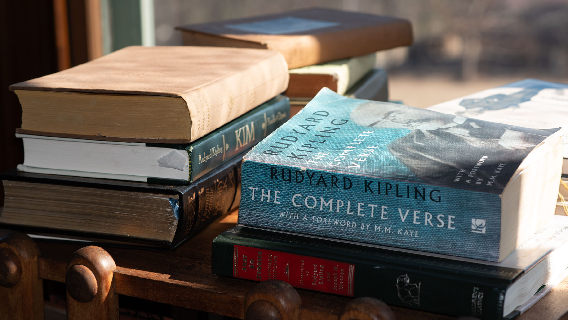 books by Rudyard Kipling are stacked on a table