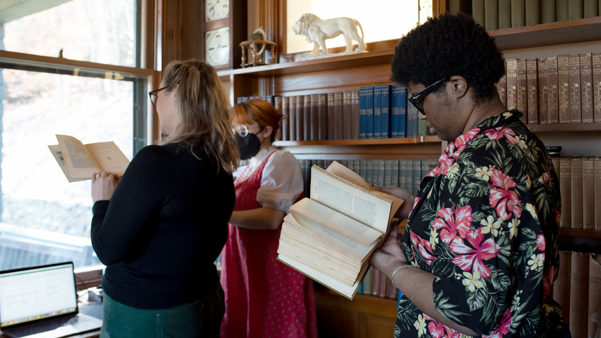 students in a personal library leaf through books